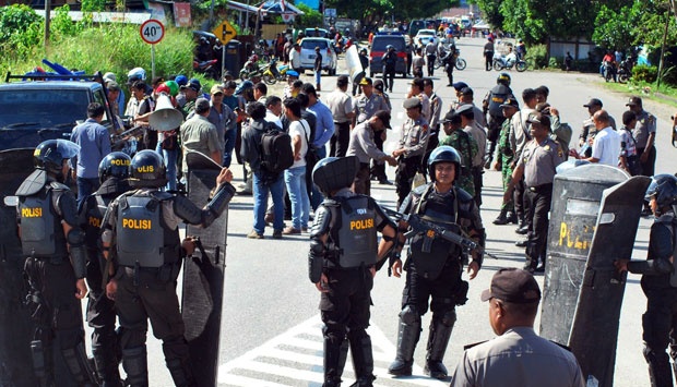 Indonesian police and soldiers after dispersing a demonstration