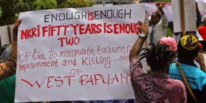 Sign from May 1 protest: Enough Is Enought